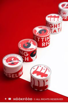 four red and white tins with the words high school on them are lined up in a row