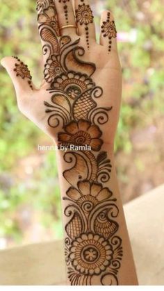 the hand is decorated with henna designs