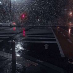 an empty cross walk in the rain at night