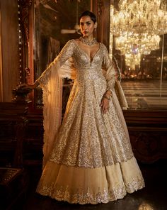 This contrasting jacket set features intricate gota patti embroidery on a grey silver tissue silk base. The outfit is paired with a soft gold embroidered skirt and an ivory tissue organza dupatta.From Seema Gujral's Falaknuma collection. DELIVERY TIMEPlease allow 8-12 weeks for your outfit to arrive. FABRIC DETAILSLehenga & Jacket - Tissue Silk Dupatta - Organza Professional cleaning only. Gold Silk Anarkali Set With Intricate Embroidery, Elegant Chanderi Lehenga With Gold Embroidery, Elegant Gold Embroidered Lehenga For Navratri, Elegant Anarkali Set With Gold Embroidery For Reception, Festive Georgette Lehenga With Gold Embroidery, Elegant Lehenga With Gold Embroidery For Navratri, Gold Sharara With Intricate Embroidery In Tissue Silk, Elegant Floor-length Dupatta With Gold Embroidery, Elegant Gown With Gold Embroidery For Diwali