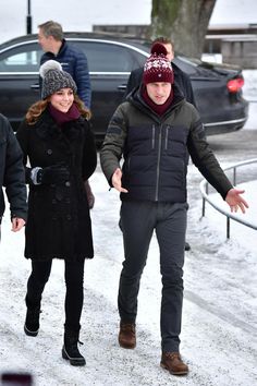 a man and woman walking in the snow