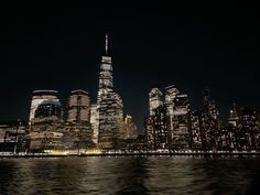 the city skyline is lit up at night