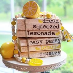 a stack of lemons sitting on top of a cake