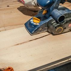 a person using a sander on a piece of wood that is being worked on