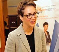 a woman standing in front of a poster