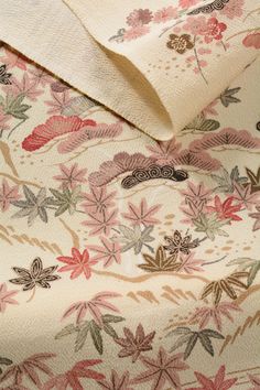 the fabric is very colorful and has many flowers on it, as well as leaves