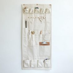 a white wall hanging with various items on it