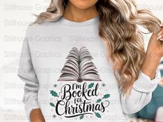 a woman wearing a sweatshirt with the words i'm booked for christmas on it