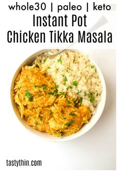 a white bowl filled with rice and curry next to a spoon on top of it