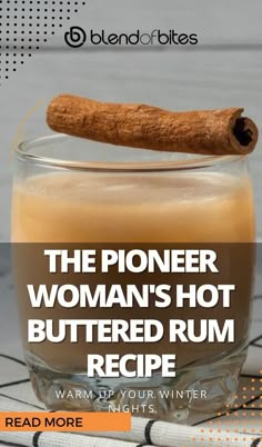 a glass filled with hot buttered rum and cinnamon on top of a table next to a