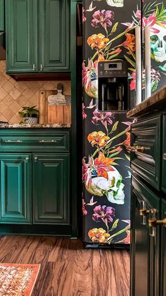 a kitchen with green cabinets and floral wallpaper