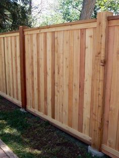 a wooden fence in front of a tree