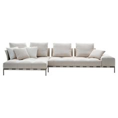 a white couch with lots of pillows on it