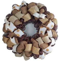 a brown and white wreath with gold bows