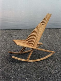 a wooden rocking chair sitting on the ground