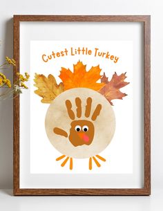 a little turkey with leaves on it's head and the words cutest little turkey written