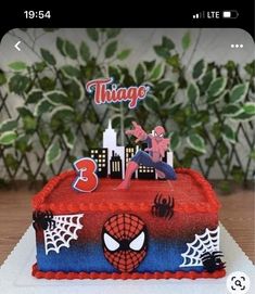 a spiderman themed birthday cake with the number three on it and an image of a woman