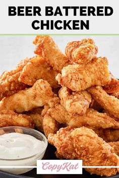 fried chicken with ranch dressing on a black plate