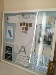 a baby's birth announcement is displayed in a shadow box