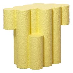 four yellow toilet paper rolls stacked on top of each other