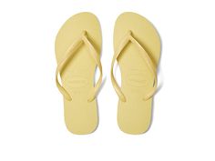 Havaianas Slim Flip Flops - Women's Sandals : Lemon Yellow : Please note: The molds for the Slim style have changed and no longer include the word Slim on the footbed. Make the 'Slim' sandal your go-to sandal for the Spring/Summer season. Rubber upper. Thong construction with embossed logo. Cushioned insole. Rubber sole. Measurements: Weight: 5 oz Product measurements were taken using size 37/38 Brazil (US Men's 5/6, Women's 7/8), width M. Please note that measurements may vary by size. Weight o Classic Beach Flip Flops With Textured Footbed, Classic Beach Flip Flops For Summer, Classic Summer Beach Flip Flops, Classic Adjustable Flip Flops For Summer, Classic Adjustable Summer Flip Flops, Yellow Flip Flops, Platform Flip Flops, Slim Style, Pastel Yellow