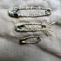 three pieces of beaded jewelry on a white cloth