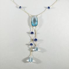 **KINDLY CHECK OUT THE VIDEO OF THE ITEM FOR A CLEARER VIEW**Details of the Necklace: Length of necklace is 16 inches. Other sizes available on request. Gemstone : Sky Blue Topaz Gemstone shape, size and weight- cushion , 20x10mm,10.08 carats Blue sapphire beads-3mm, 9ec,5.55 carats Sky blue topaz drops-7x5mm,3.25 carats, 2 pec Total Gemstone weight: 18.88 carats Metal: GOLD Purity: 14K (58.33%)approx Gold Weight: 1.63 grams Total weight: 5.41 grams Aunthtic sky Blue Topaz cushion, blue sapphire Blue Gemstones With Accents Fine Jewelry, Elegant Blue Tanzanite Gemstones, Fine Jewelry Briolette Blue Topaz Jewelry, Fine Jewelry Blue Topaz Briolette, Blue Topaz Gemstones With Gemstone Accents For Gift, Elegant Necklace With Blue Topaz And Natural Stones, Blue Topaz Drop Necklaces, Elegant Blue Topaz Necklace With Natural Stones, Blue Drop Necklaces With Blue Topaz