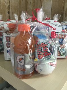 plastic bags filled with sports items on top of a wooden table next to bottles of liquid