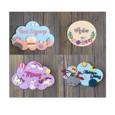 four wooden plaques with different designs and names on the front, one for each child's name