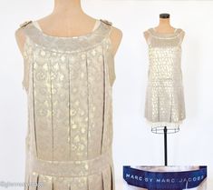 "~ 1990s gold flapper-like sleeveless dress ~ Wonderful gold metallic fabric shift ~ Fully lined in creme rayon with organza ruffle trim ~ Side invisible zipper 9\" (22.86 cm) ~ Excellent Label: Marc Jacobs Bust- 34\" (86.5 cm) Waist- 28\" (71 cm) Hips- 38\" (96.5 cm) Length- 37.5\" (96 cm) More Incredible Vintage:  glennasvintageshop.etsy.com Vintage Jewelry:  glennasjewels.etsy.com Instagram @glennas_clothing Facebook  https://www.facebook.com/glennasclothing" Gold Gatsby Style Flapper Dress, Vintage Summer Evening Flapper Dress, Summer Gatsby Style Flapper Dress For Vintage Events, Formal Sleeveless Art Deco Flapper Dress, Art Deco Summer Dresses For Vintage Events, Summer Formal Sleeveless Flapper Dress, Summer Art Deco Dress For Vintage Events, Gold Gatsby Flapper Dress For Summer, Fitted Gold Flapper Dress In Art Deco Style