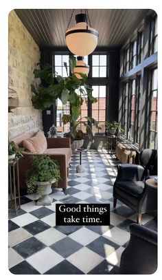 the sun shines through large windows into a room with black and white checkered flooring