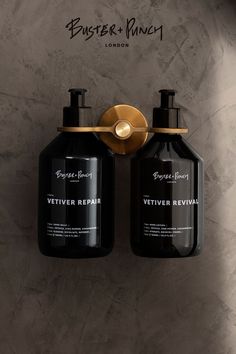 two bottles of vetiver repair are hanging on the wall next to each other,