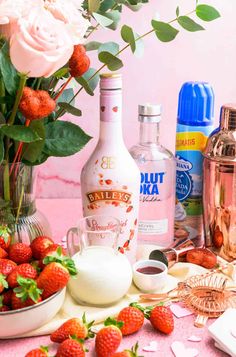 a table topped with lots of different types of drinks