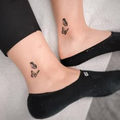 two small tattoos on the feet of people with butterflies tattooed on their ankles and ankle