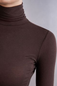 Long-sleeve top in soft modal cashmere ultralight with a high-neck design. Due to transparent nature of ultralight material, we recommend pairing with Ultralight Microfiber Top. Winter Seamless Tops, Brown High Neck Top For Layering, Brown Fine Knit Turtleneck Top, Seamless Turtleneck Top For Layering, Solid High Neck Fine Knit Top, Seamless Second-skin Tops For Fall, Winter Seamless Tops For Layering, Elegant Seamless Tops For Winter, Fitted Brown Funnel Neck Top