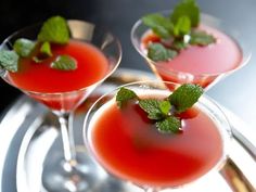 two martinis with mint garnish sit on a silver tray