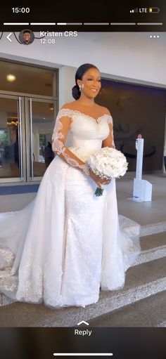 a woman in a white wedding dress standing on steps