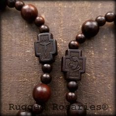 two rosarys with wooden beads and an image of jesus on the cross hanging from them