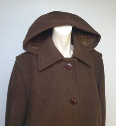 "Beautiful vintage brown coat whit hood tartan pattern on inside  70s vintage mongomery coat high quality  Salko Austria  exclusively  made Baur Foradori original loden  tirol   detachable hood armpit opening coat is in excellent condition leather buttons on the front two side pockets heavy stitching Measurenants shoulder  13cm  5\" sleeves    63cm  25\" bust          120cm   47\" waist         124cm  49\" hips           136 cm    53\" shoulder to shoulder   46cm  18\" total length back   100cm  39\"" Brown Hooded Wool Coat For Fall, Brown Hooded Wool Coat For Winter, Vintage Brown Wool Coat For Winter, Vintage Brown Long Wool Coat, Vintage Wool Hooded Outerwear, Vintage Hooded Wool Outerwear, Vintage Hooded Jacket With Double-lined Hood For Fall, Vintage Fall Hooded Jacket With Double-lined Hood, Fall Vintage Hooded Jacket With Double-lined Hood