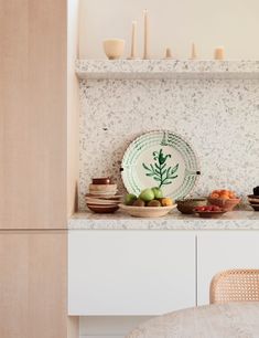 a plate sitting on top of a counter next to bowls