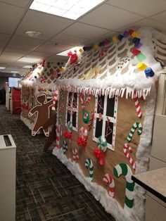 an office cubicle decorated for christmas with gingerbreads and candy canes on the walls