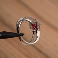 It is a lab ruby ring. The main stone is 7mm*7mm round cut, weight about 1.66 carats. The basic metal is sterling silver and plated with rhodium. To change the metal to a solid gold (white/rose) or platinum is also available, please ask for a quotation if you want. You can also go to my shop Home for more elegant rings: https://www.etsy.com/shop/godjewelry?ref=hdr_shop_menu More ruby rings: https://www.etsy.com/shop/godjewelry?ref=seller-platform-mcnav&section_id=20709238 Customization is al Lab-created Ruby Birthstone Promise Ring, Promise Ring With Lab-created Ruby, Round Cut Ruby Ring For Promise, Round Cut Ruby Promise Ring, Promise Ruby Ring With Lab-created Ruby, Promise Ruby Ring With Cubic Zirconia, Promise Lab-created Ruby Ring, Promise Ruby Ring, Lab-created Ruby Ring With Halo Setting For Promise