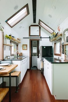 the kitchen is clean and ready to be used as a dining area in this tiny home