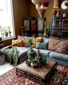 a living room filled with furniture and lots of pillows on top of it's covers