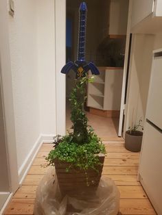 a planter with plants in it sitting on top of a wooden floor