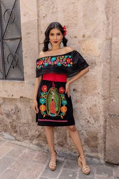 This Beautiful Mexican Our Lady of Guadalupe Colorful  Dress is the perfect dress for a casual outfit or special event.  It reflects the Mexican culture through its unique design and vibrant colors. It has elastic around the waist and is embroidered by Artisanal Machine by Mexican Artisans in Puebla, Mexico.  Purchase the belt here: https://www.etsy.com/es/listing/690070823/fajo-artesanal-mexicano-accesorios-para?click_key=e33d221dfcd119f9447c163af9db2132573403c7%3A690070823&click_sum=4aacb61c&r Black Short Sleeve Dress For Fiesta, Mexican Traditional Dress, Traditional Mexican Dress, Mexican Dress, Colorful Dress, Our Lady Of Guadalupe, Lady Of Guadalupe, Mexican Dresses, Floral Embroidered Dress