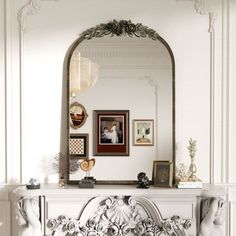 an ornate fireplace mantel in a white living room