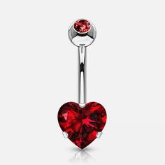 a heart shaped belly ring with a red crystal stone in the center and an attached bar