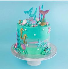 a cake decorated with seahorses, starfish and seashells