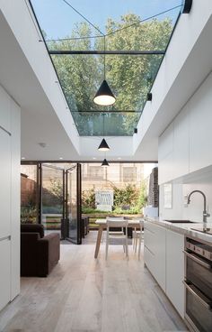 an open kitchen and dining area with skylights